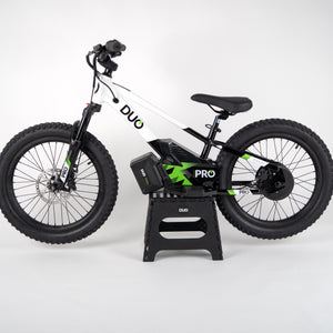 “DUO 20″ Podium Pro kids electric balance bike – side profile, black, on stand”